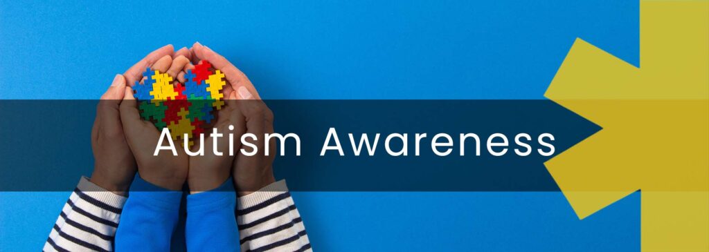 Autism Awareness - image of child hands in adult hands both craddling a heart made up of multi coloured jigsaw pieces which represents autism