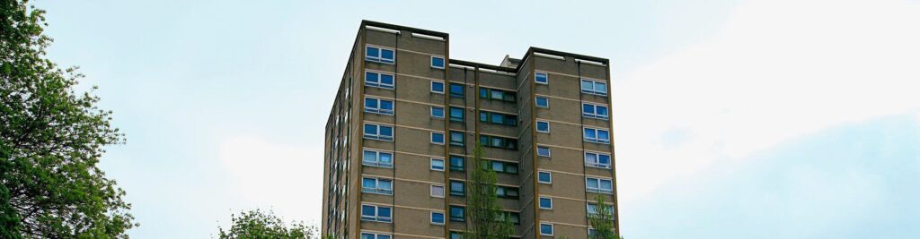 A high-rise residential block of flats in England, requiring a designated fire safety responsible person to implement updated 2026 evacuation regulations.
