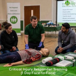 Instructor demonstrating catastrophic bleed trauma care on a medical training manikin during a face-to-face critical injury course.