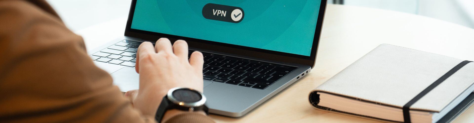 Data Protection Policy banner - person typing on a laptop showing a secure VPN connection