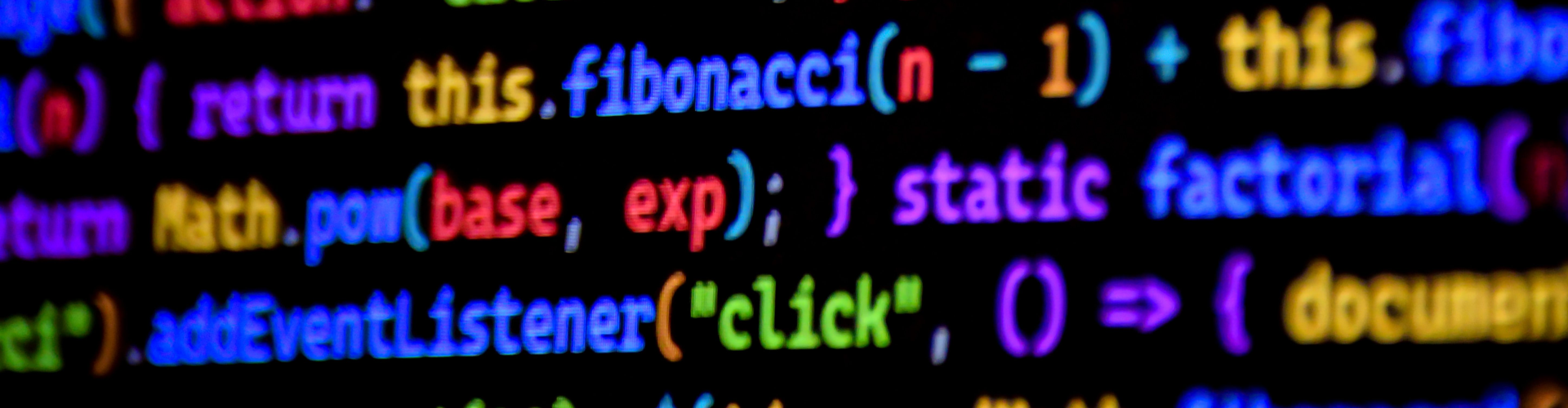 Close-up of a computer screen showing colourful syntax-highlighted code, including JavaScript functions such as fibonacci, Math.pow and addEventListener, displayed on a dark background.